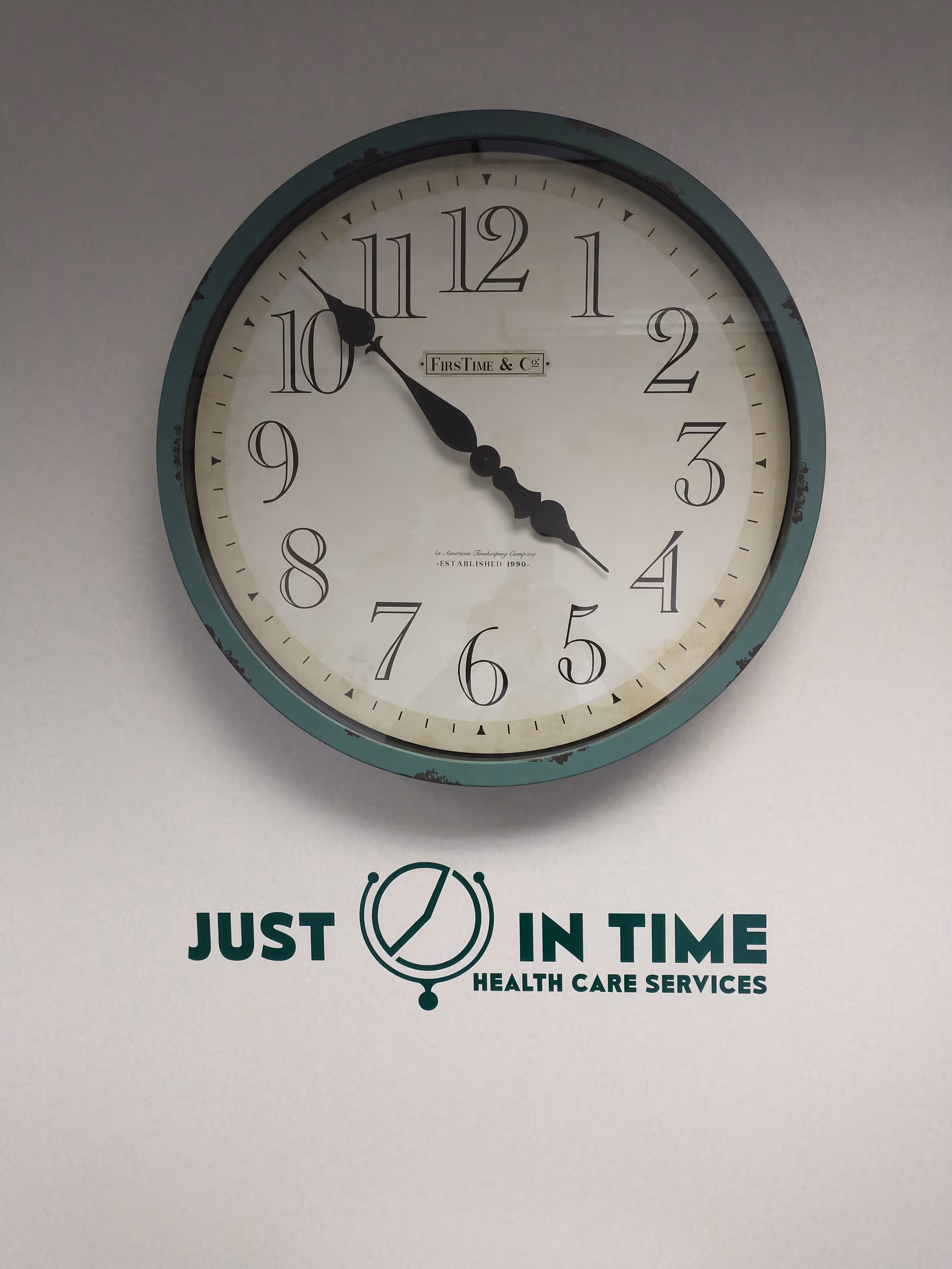 A large vintage wall clock with Just In Time Health Care Services logo underneath.