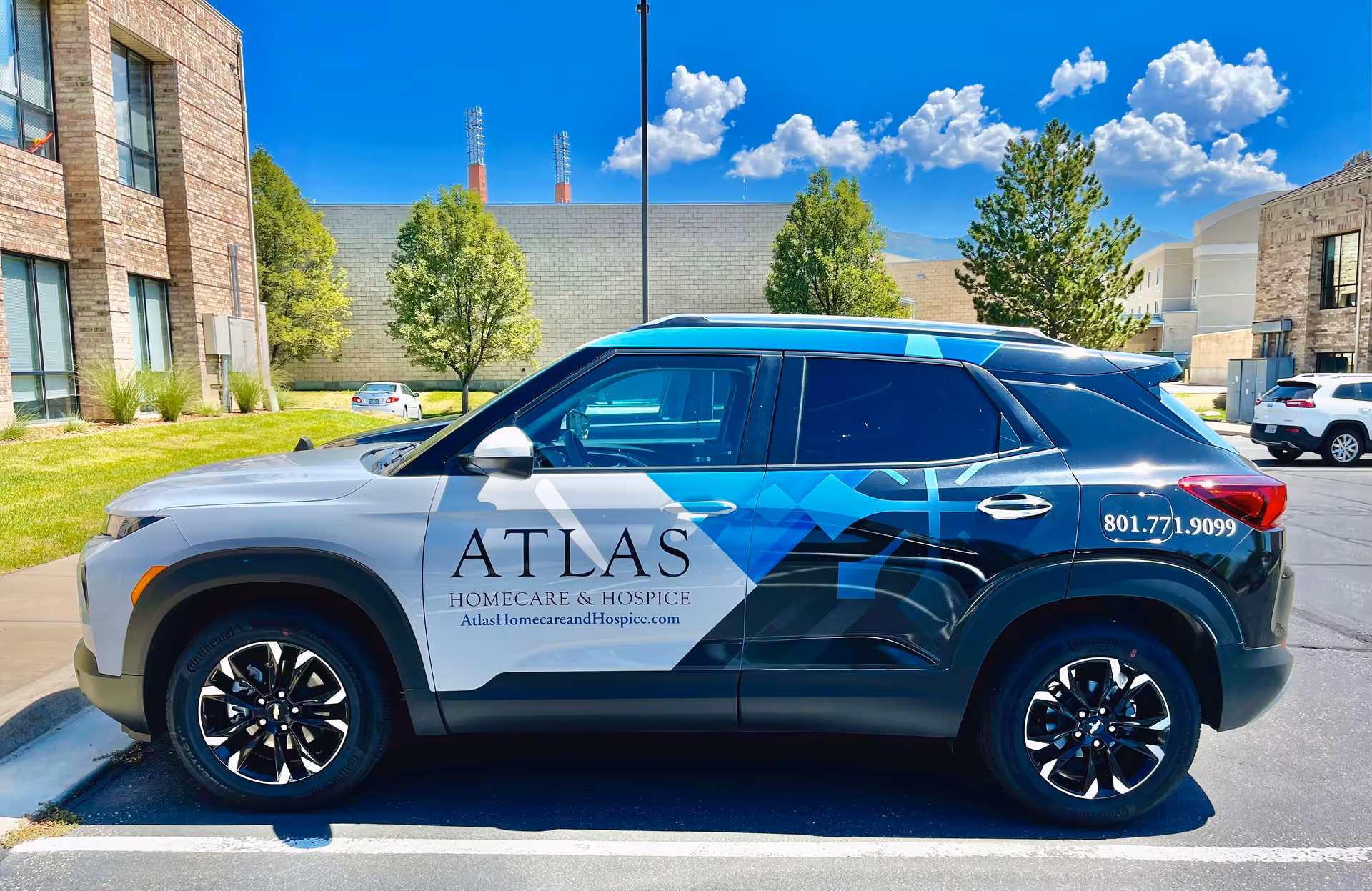 Branded Atlas Homecare and Hospice SUV parked in a lot beside a building.