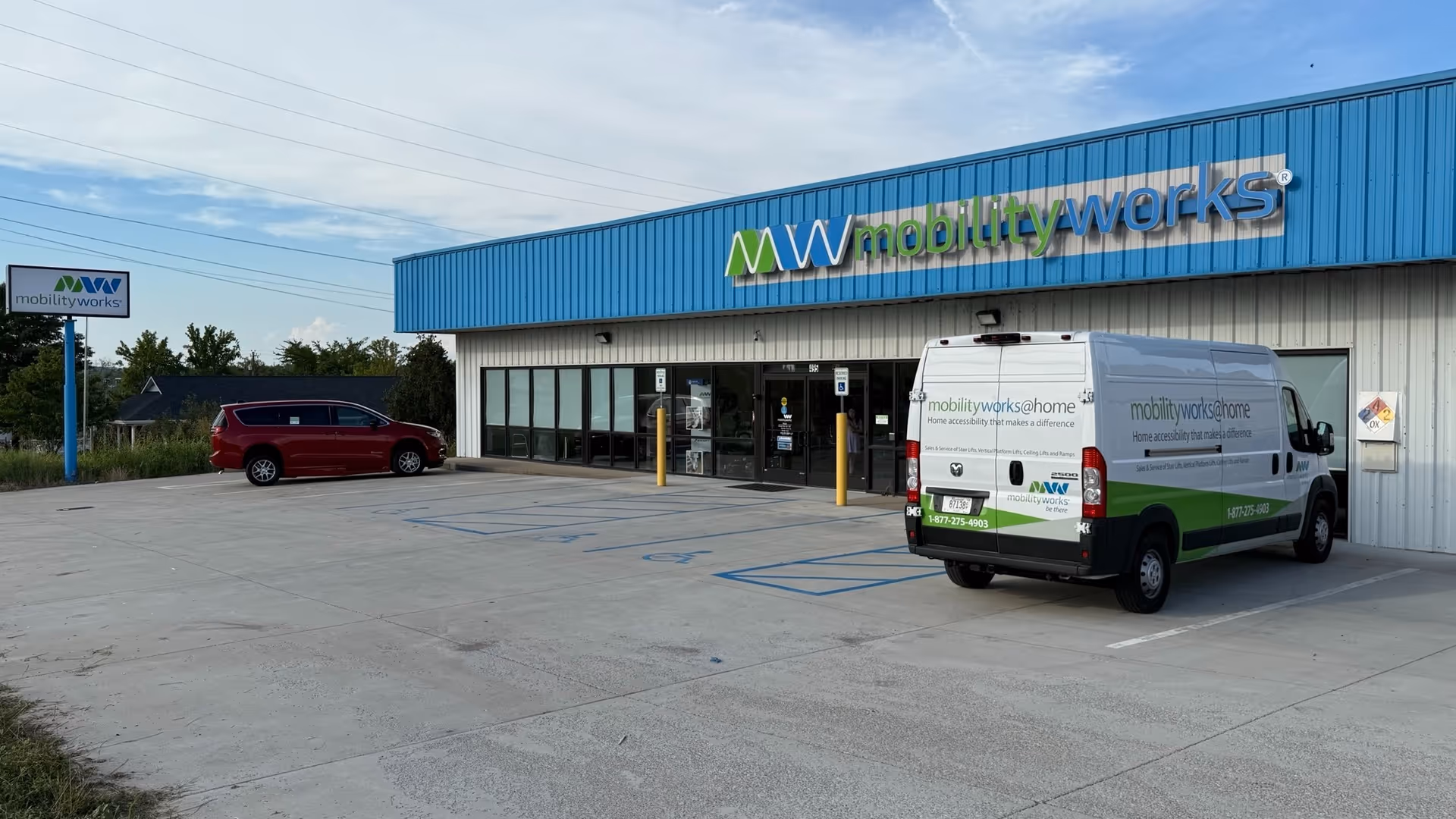 Blue MobilityWorks storefront with a white van parked in front of the building.