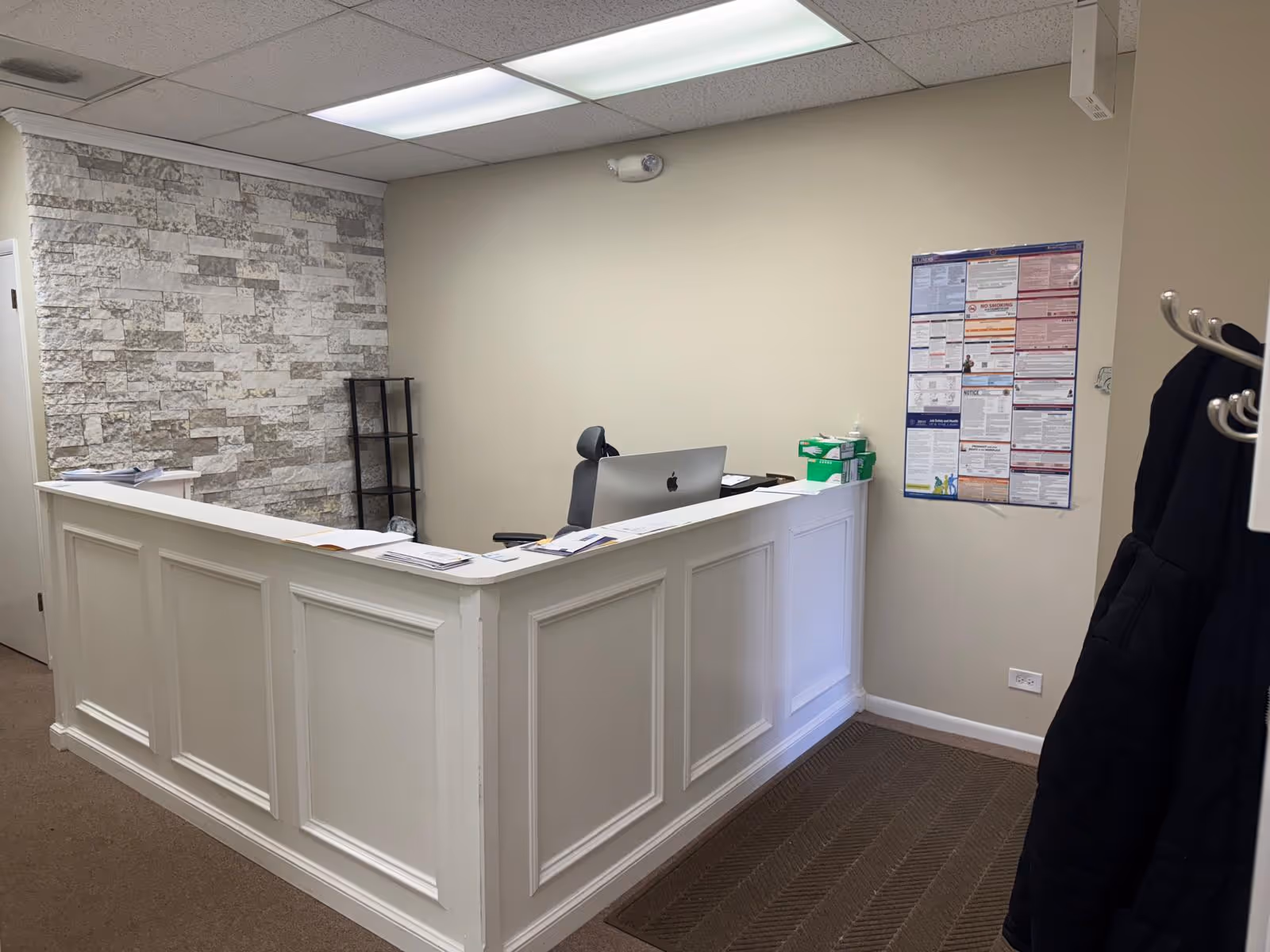 Reception desk with computer in a modern front-office area of a senior living facility.