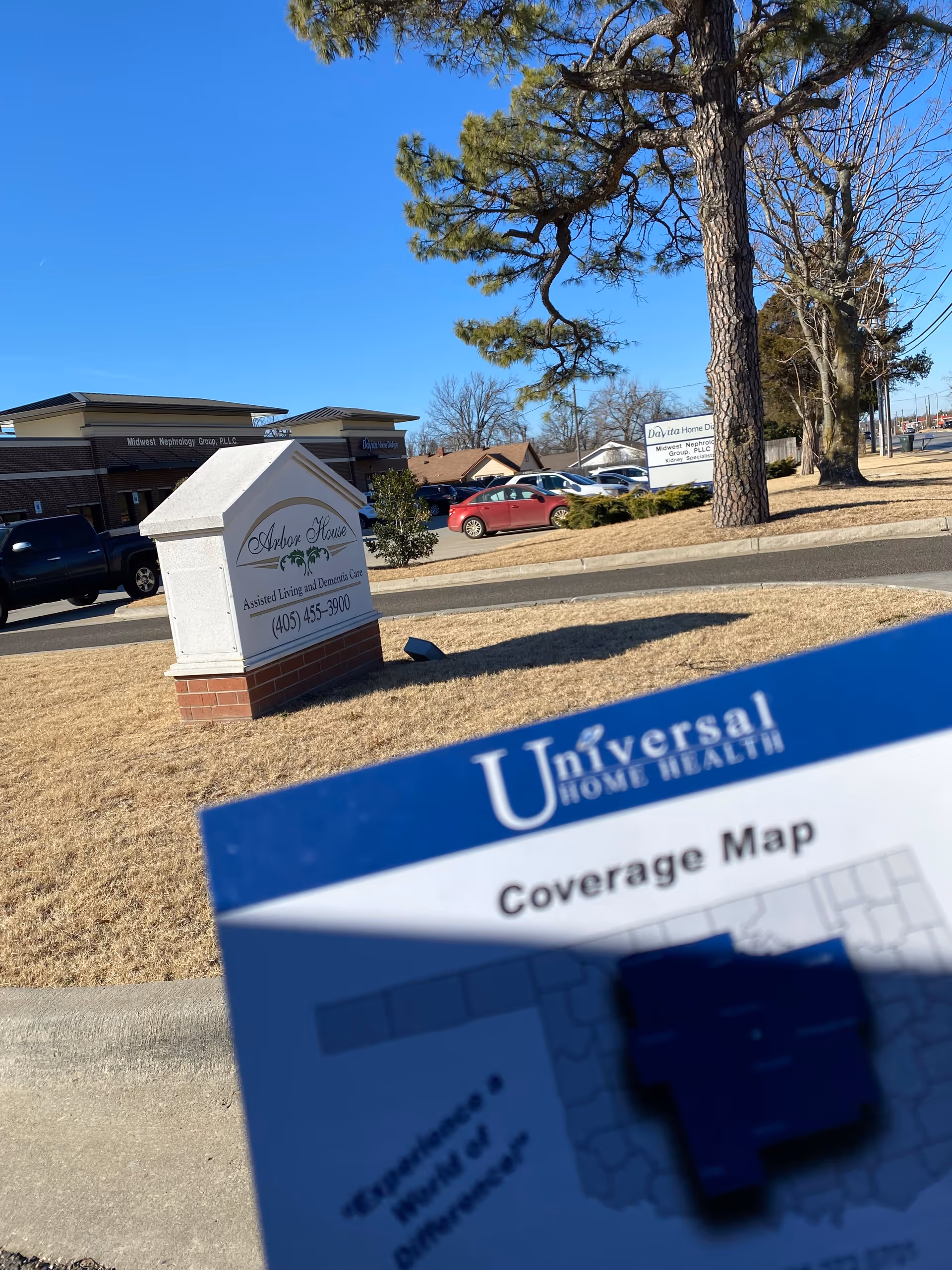 Exterior view of Universal Home Health site with Arbor House sign and map in foreground.