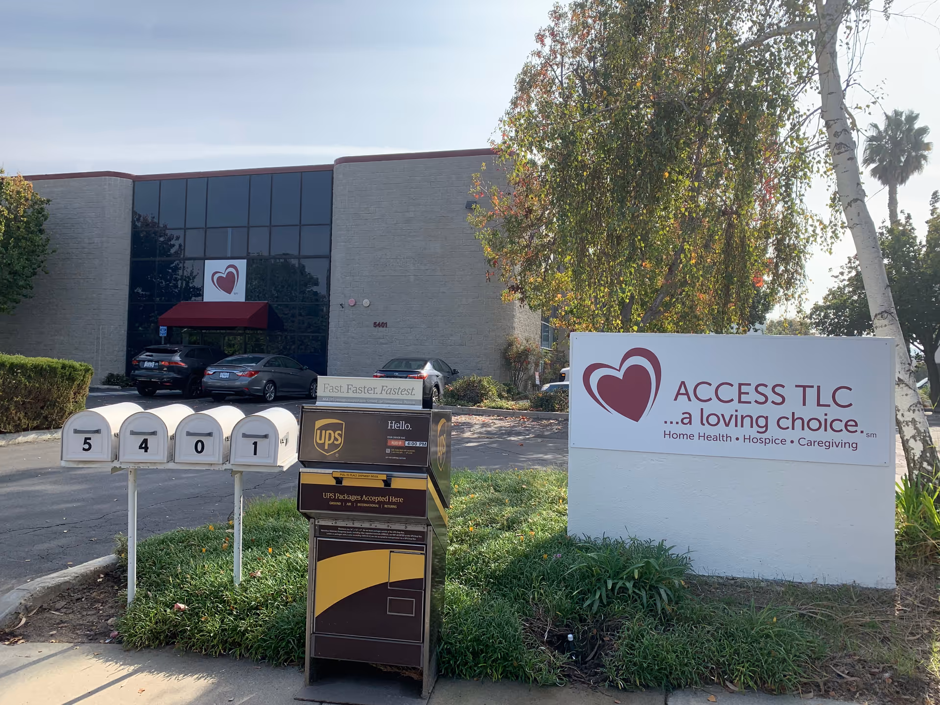 Exterior view of Access TLC building with sign, parking, and surrounding landscaping.