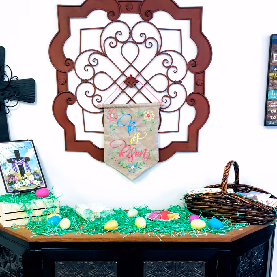 Decorative Easter display on a wooden cabinet with a basket and banner