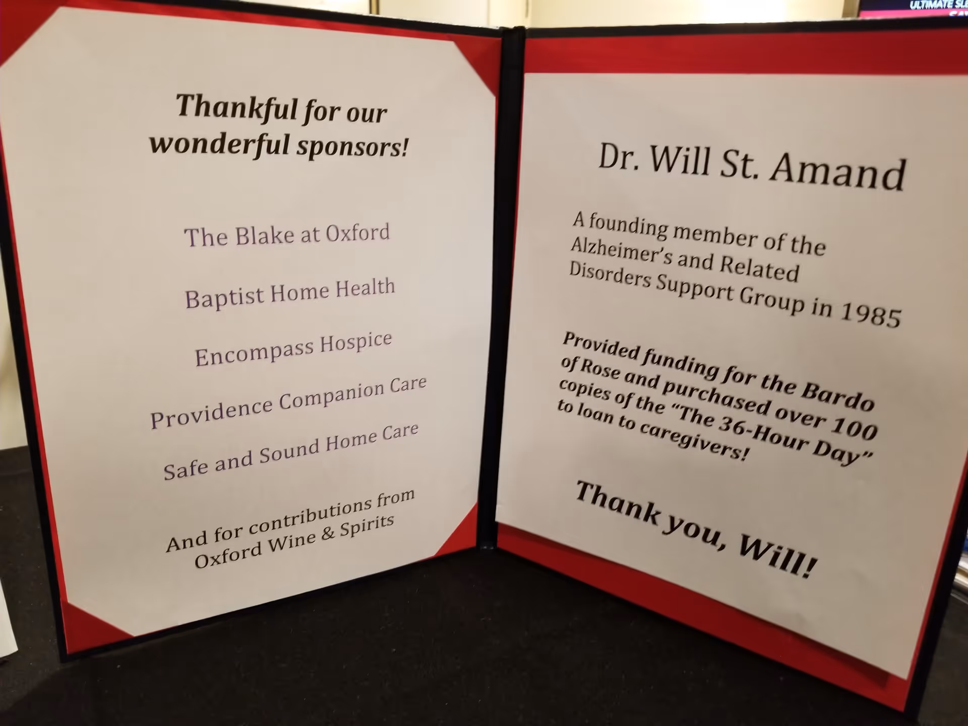 Two display boards with sponsor names and Dr. Will St. Amand’s biography.