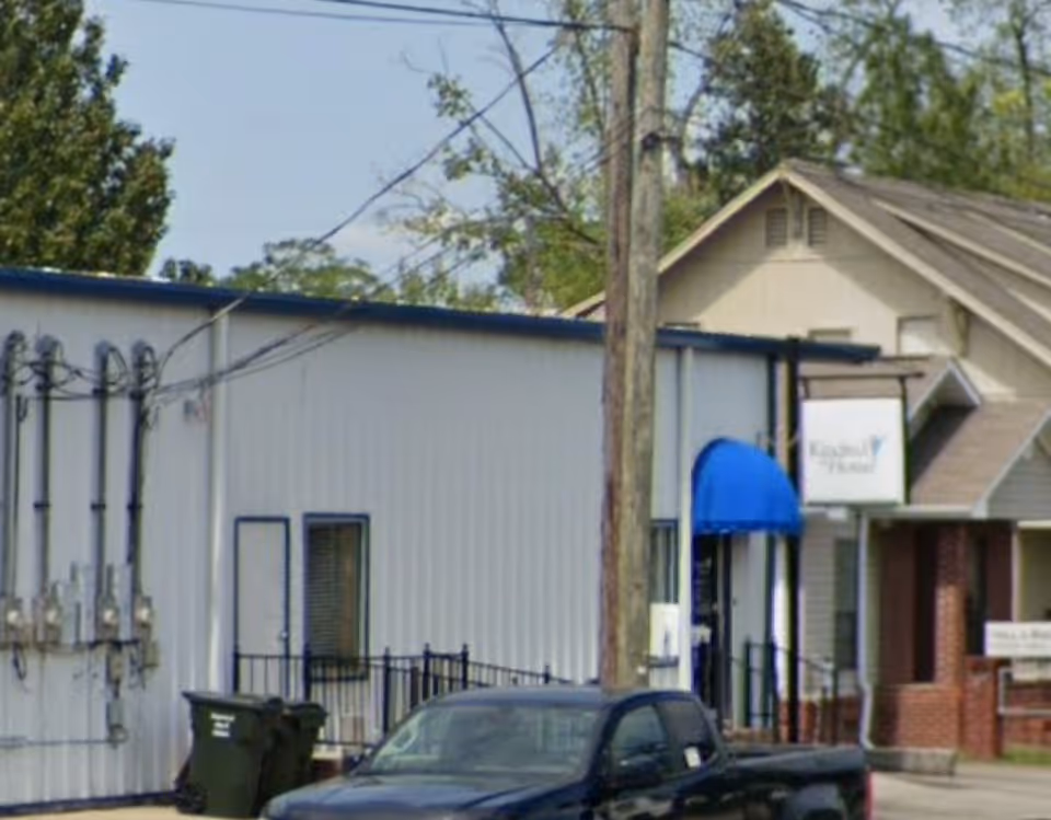 Exterior view of a CenterWell Home Health facility with a blue canopy entrance