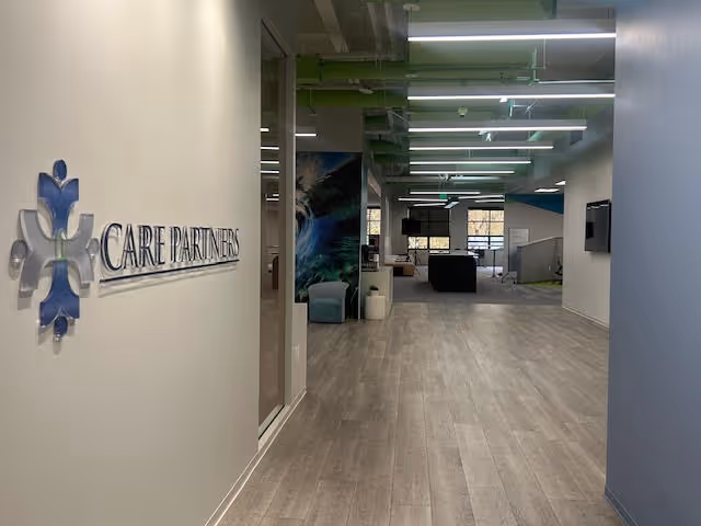 Bright, modern interior lobby with Care Partners sign and open seating areas