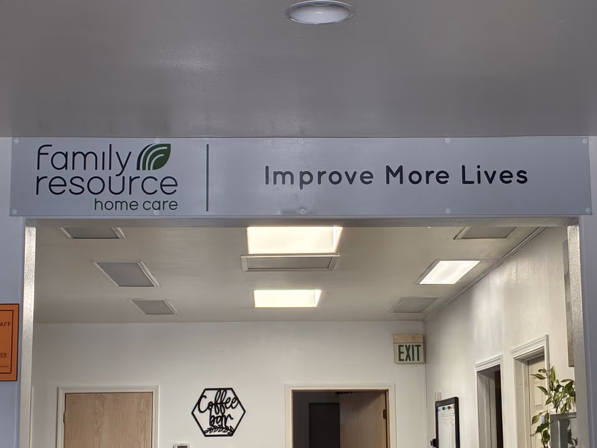 Indoor hallway inside Family Resource Home Care building with sign and exit door