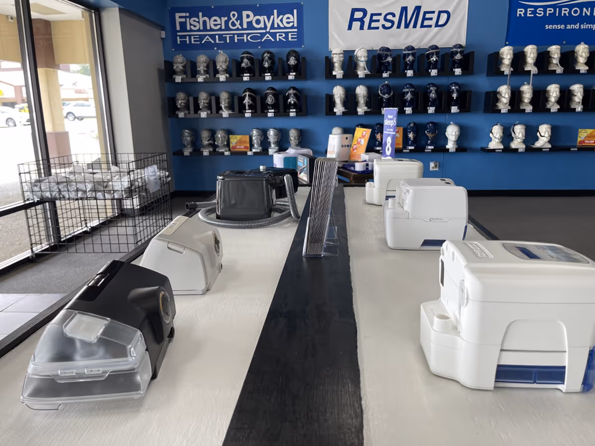 CPAP supply showroom with mask displays on blue walls and a service counter.
