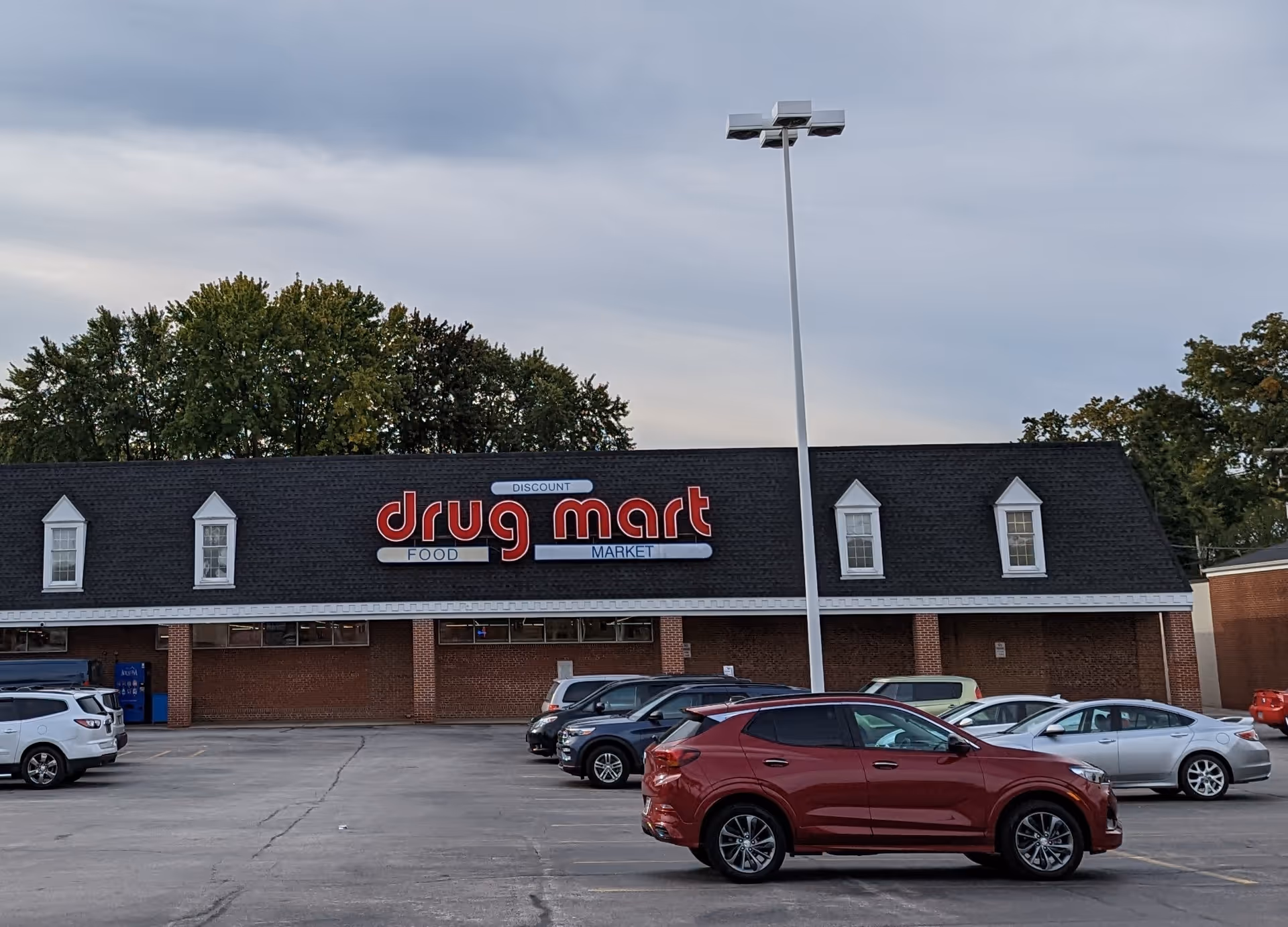 Discount Drug Mart storefront with brick exterior and a parking lot in front.