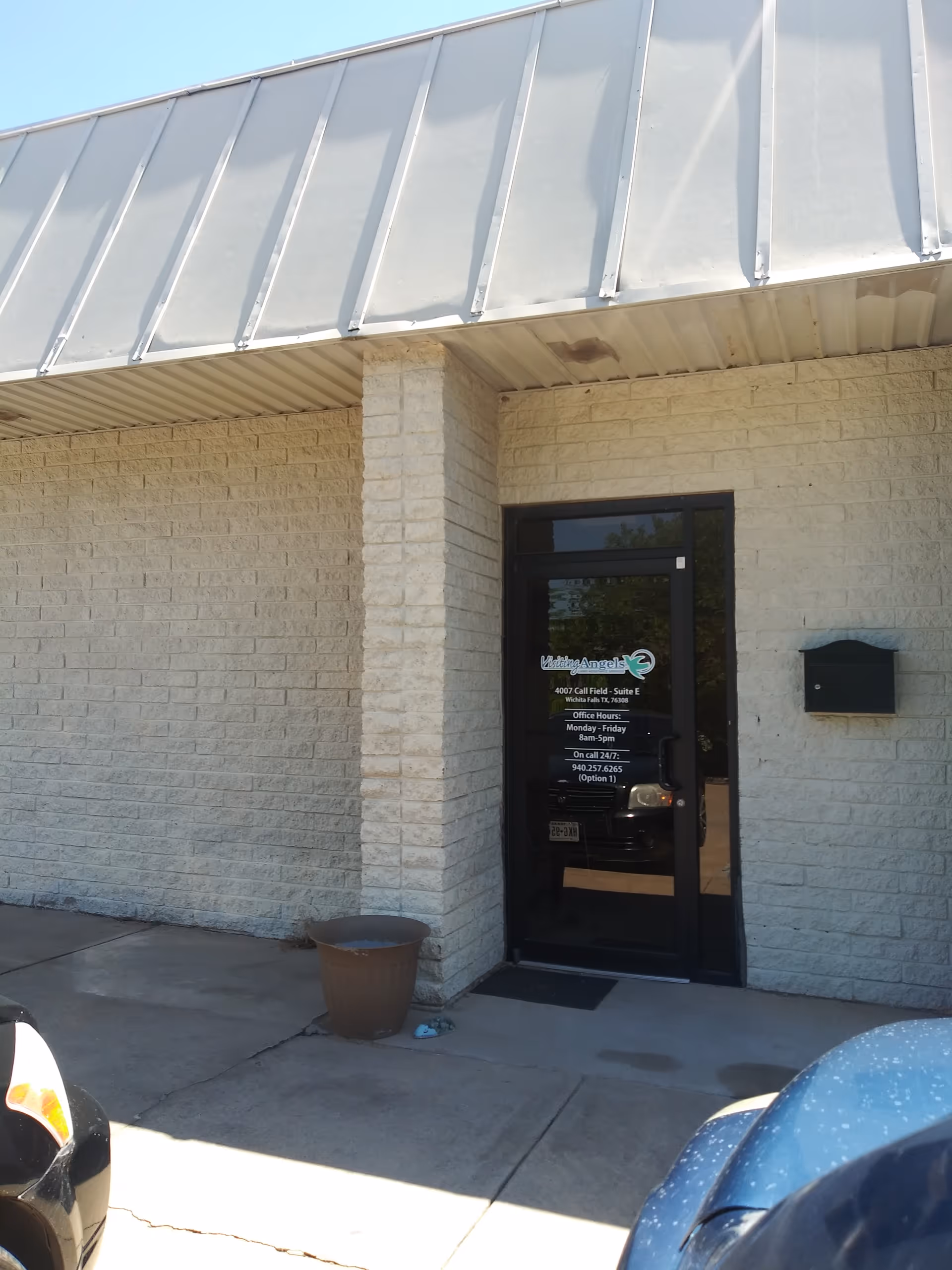Exterior view of the Visiting Angels entrance with glass door and brick walls