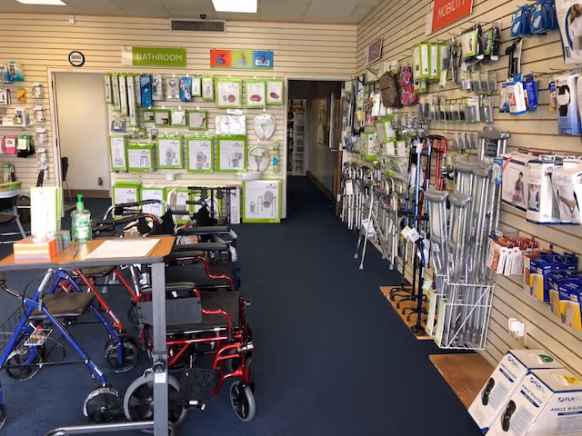 Indoor showroom in a senior facility with mobility aids, walkers, canes, and bathroom accessories.