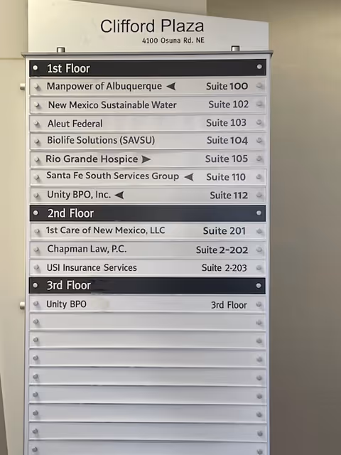 Interior directory sign listing floors and tenant suites at Clifford Plaza.