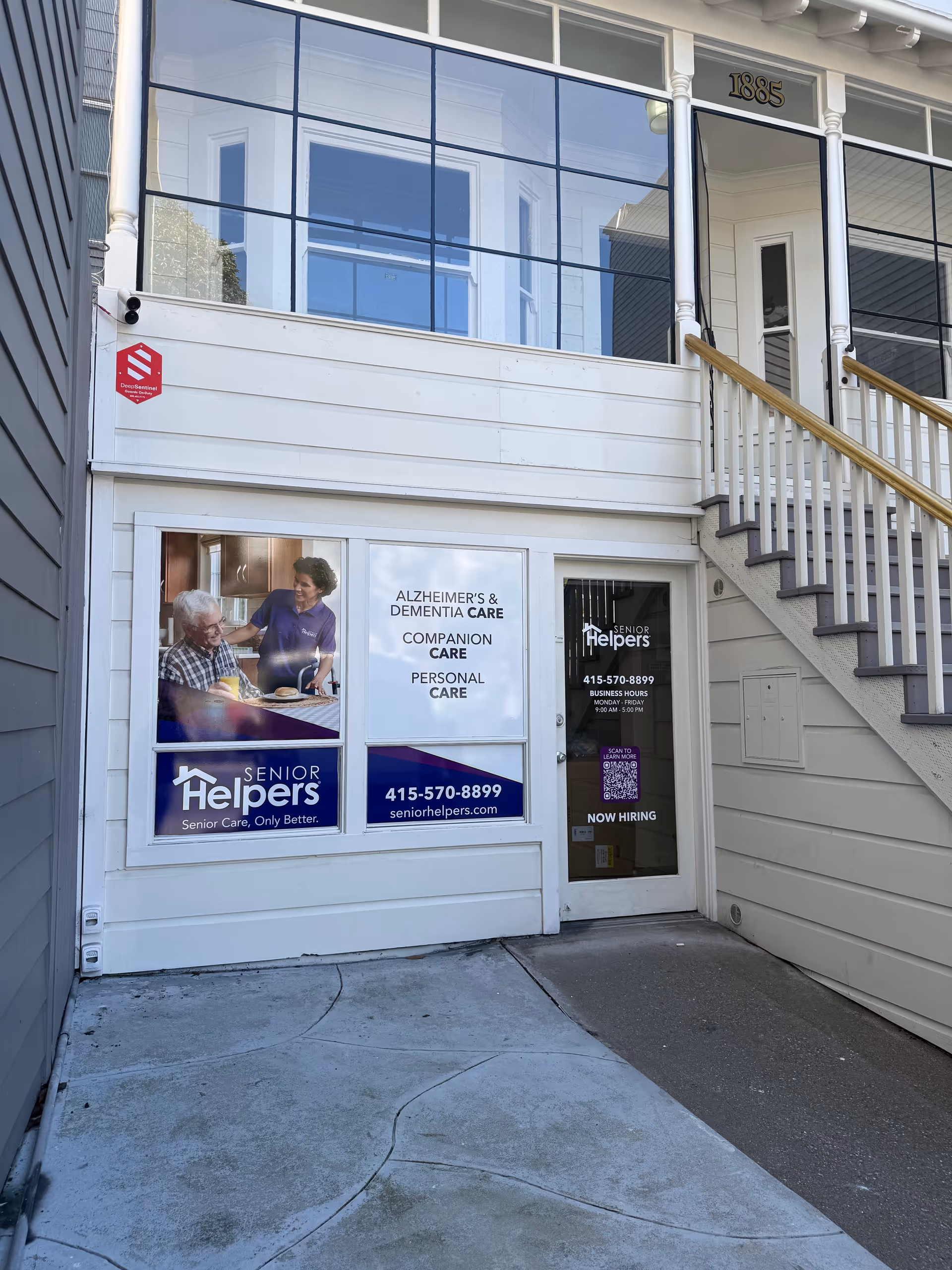 Exterior view of a Senior Helpers facility entrance with windows and stairs.
