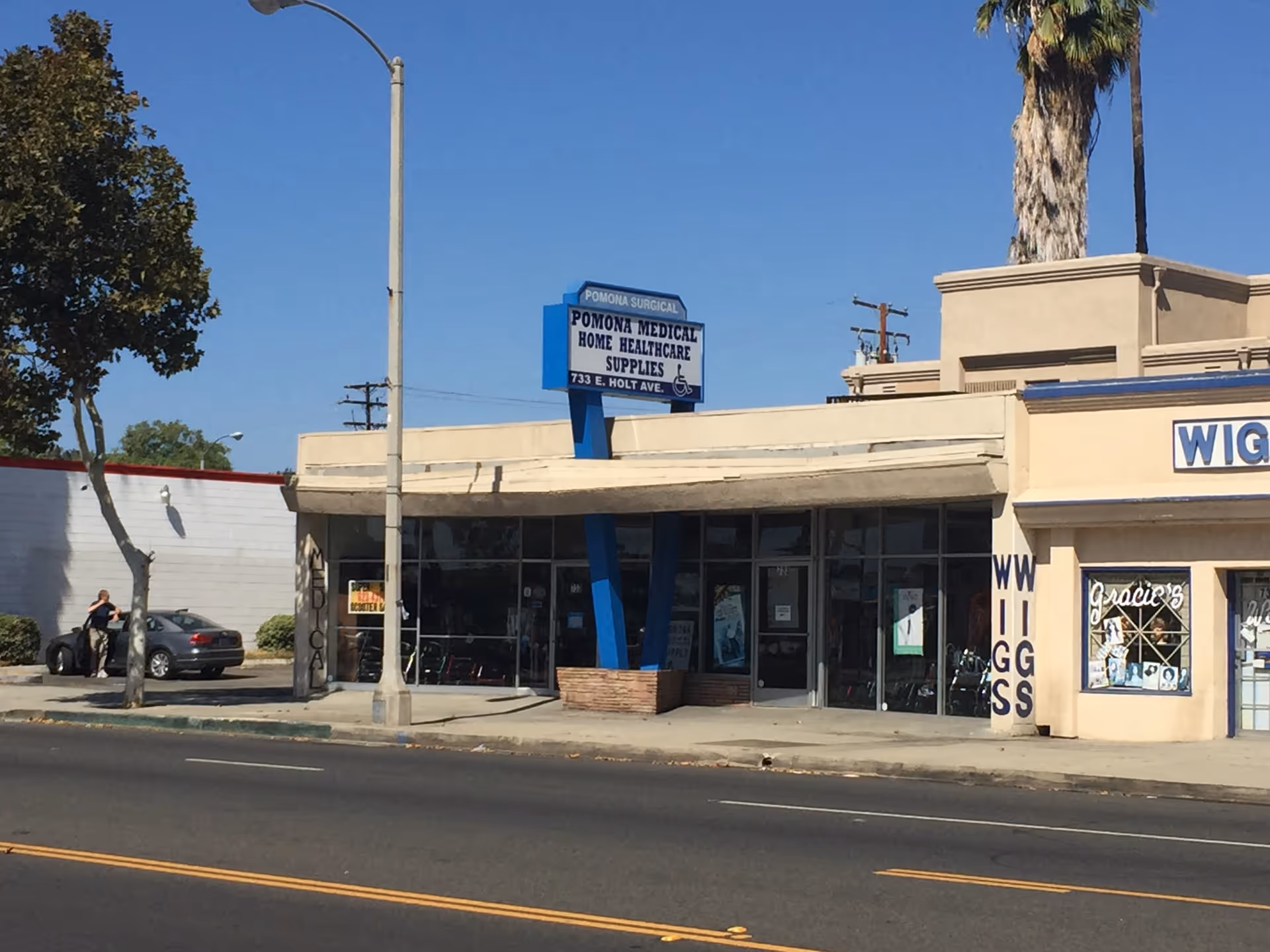 Street view of Pomona Medical Supply storefront with glass windows and blue columns.