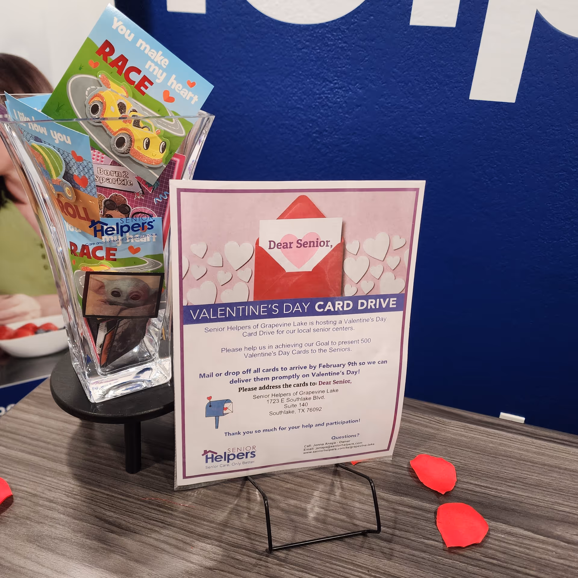 Valentine's Day promotion brochures and cards displayed on a wooden table at Senior Helpers.