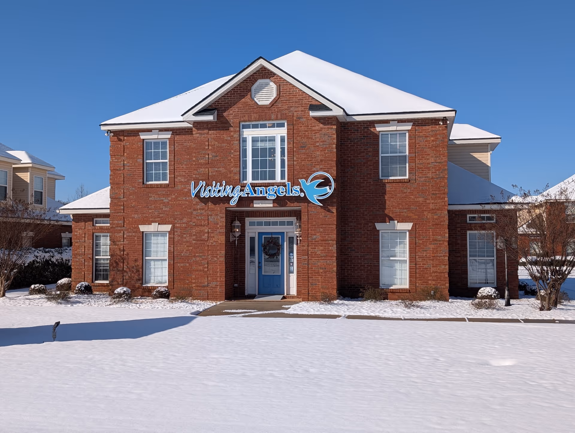 Front view of Visiting Angels senior home care building in snowy conditions