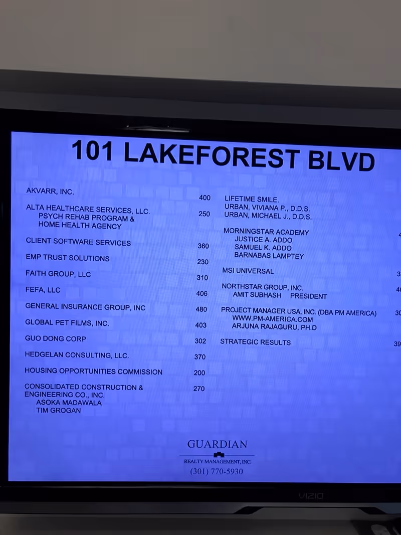 Blue directory board listing tenants and addresses at 101 Lakeforest Blvd inside a facility lobby.