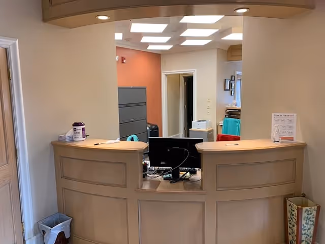 Reception desk with computers in a clinic lobby.