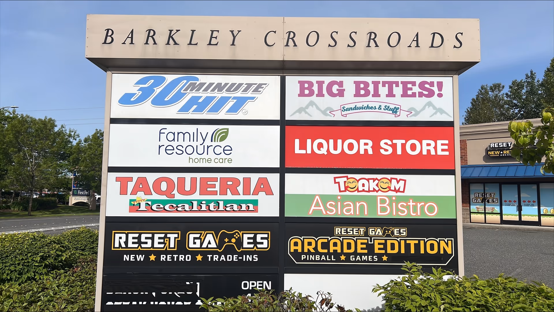 Exterior signboard at Barkley Crossroads listing multiple storefronts and logos