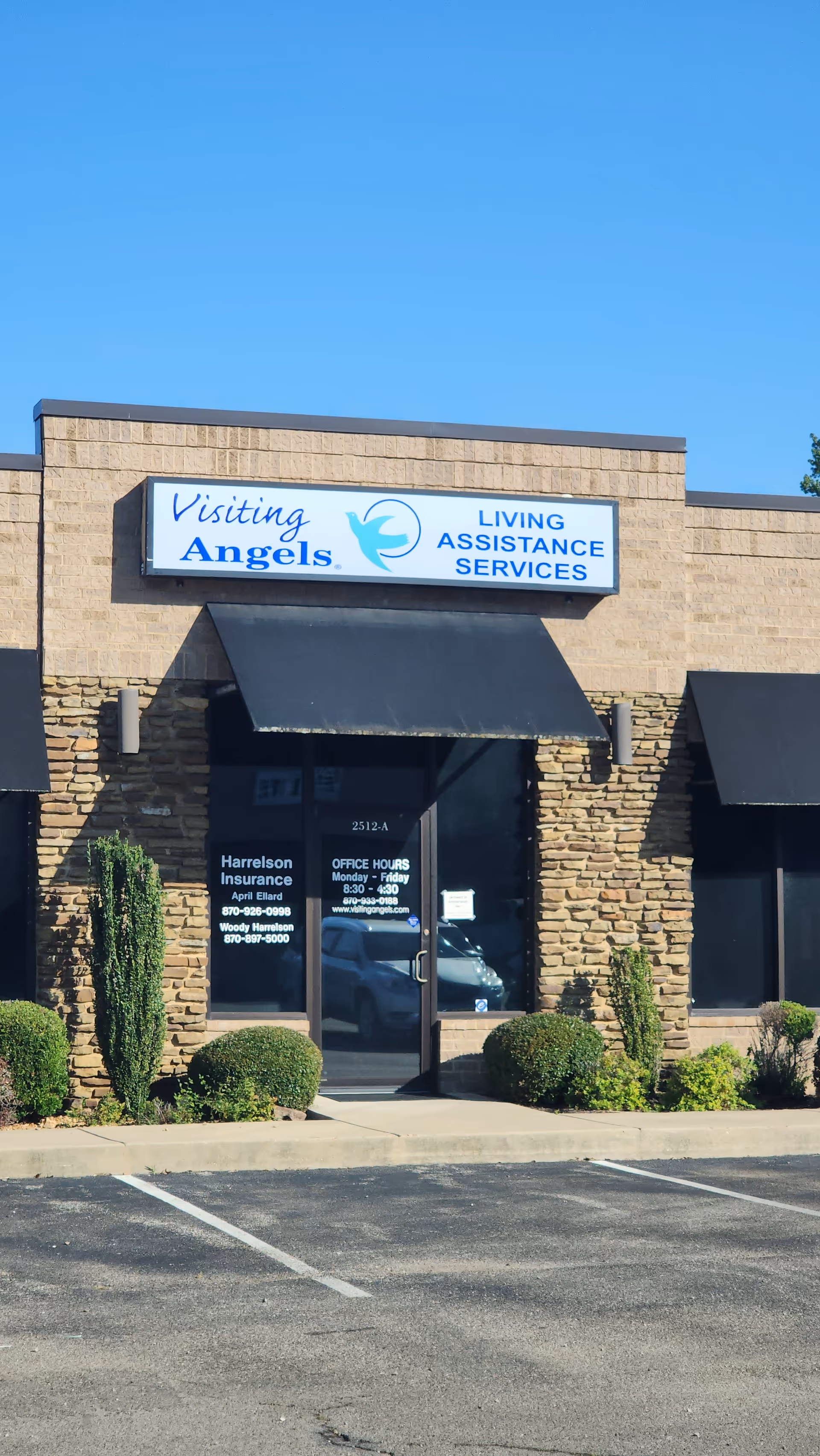 Exterior of Visiting Angels building with sign for Living Assistance Services