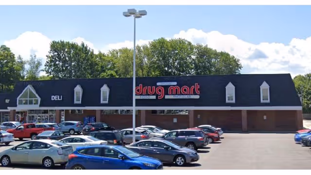 Exterior view of Discount Drug Mart storefront with a parking lot in front.
