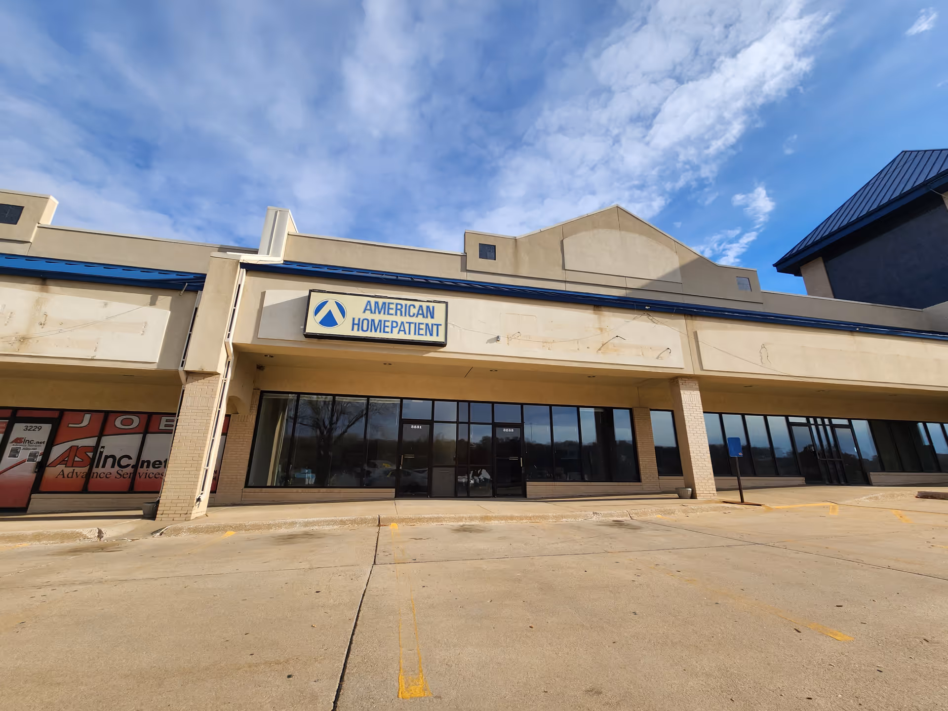 Front view of an American HomePatient building with large glass storefront windows.