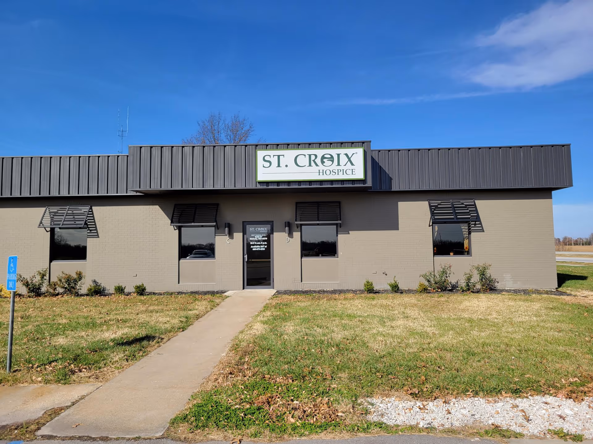 Front exterior of a single-story hospice building with a St. Croix Hospice sign.