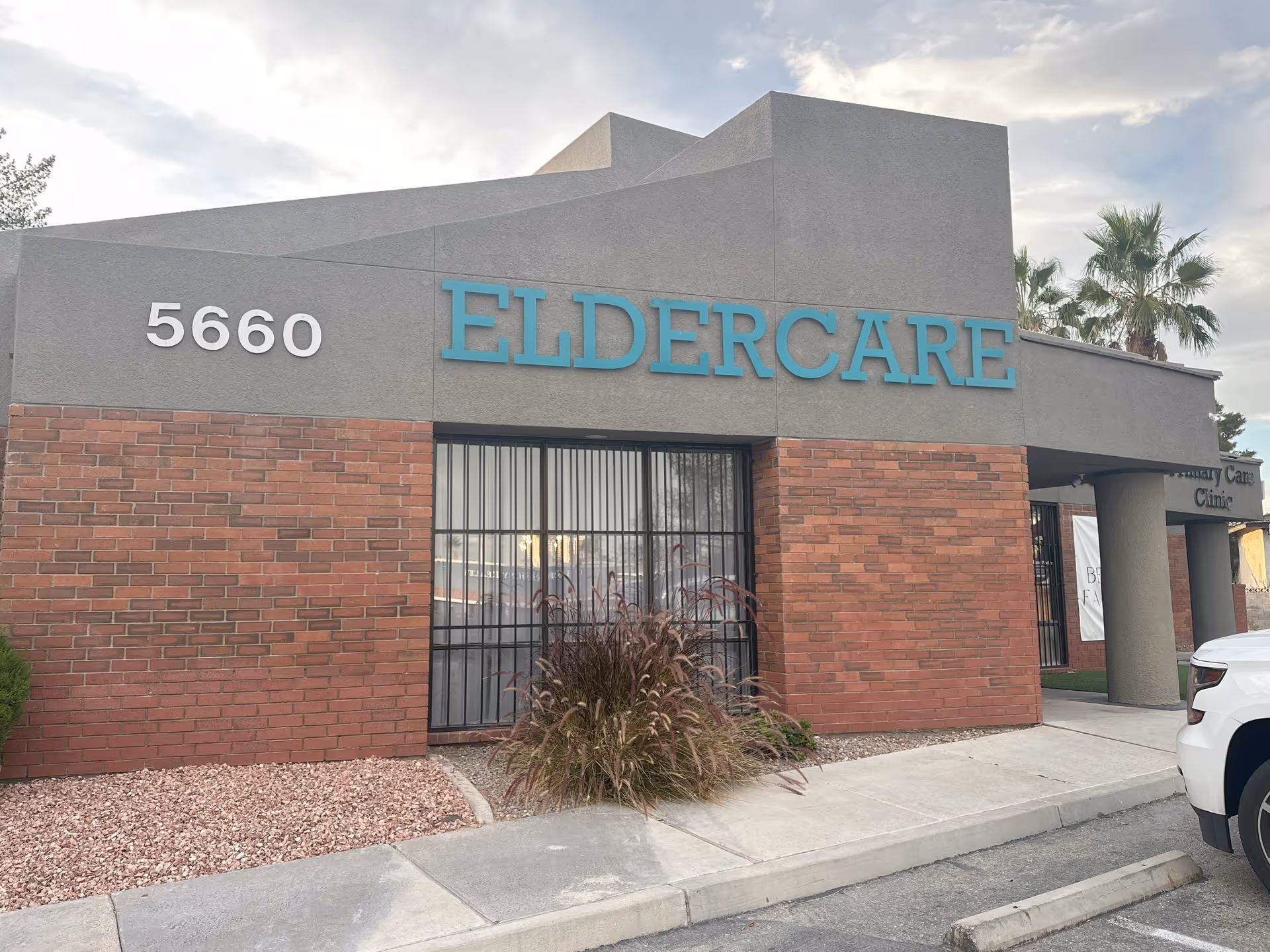 Exterior view of Eldercare facility with brick facade and blue sign reading ELDERCARE.