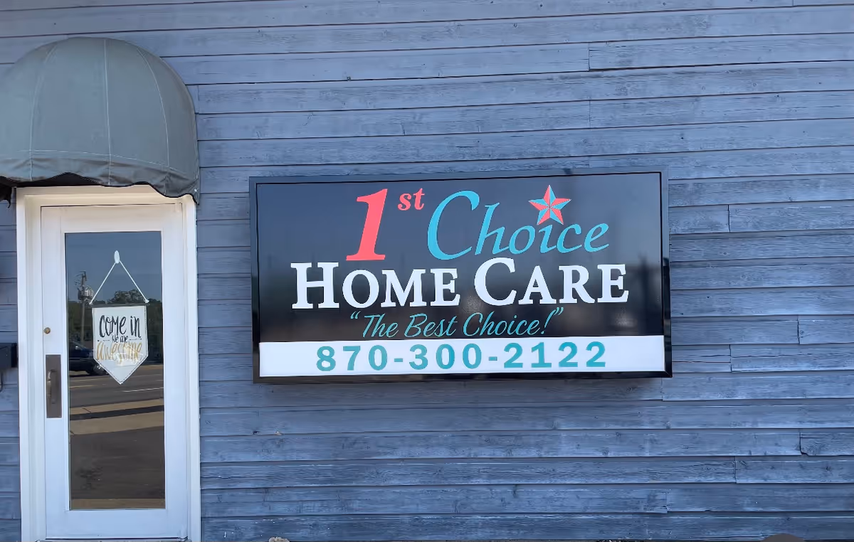 Blue wooden building exterior with a large sign reading 1st Choice Home Care and phone number.