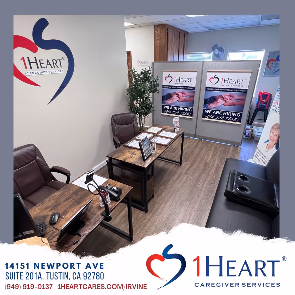 Office reception area with desks, chairs, and 1Heart Irvine banners.