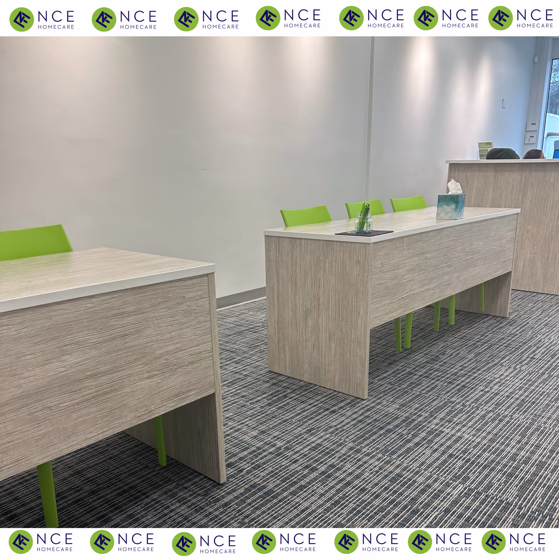 Modern reception area with light wood furniture and lime green chairs.