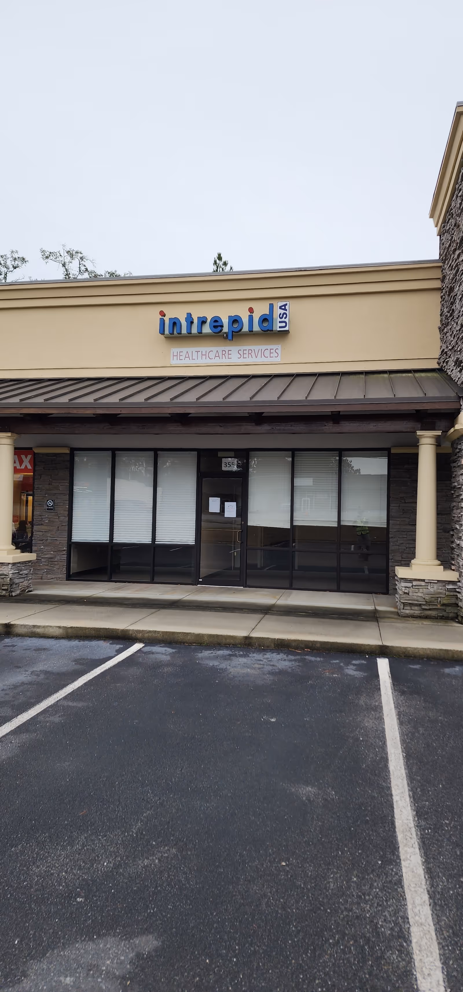 Exterior front of a beige building with an Intrepid USA Healthcare Services sign.