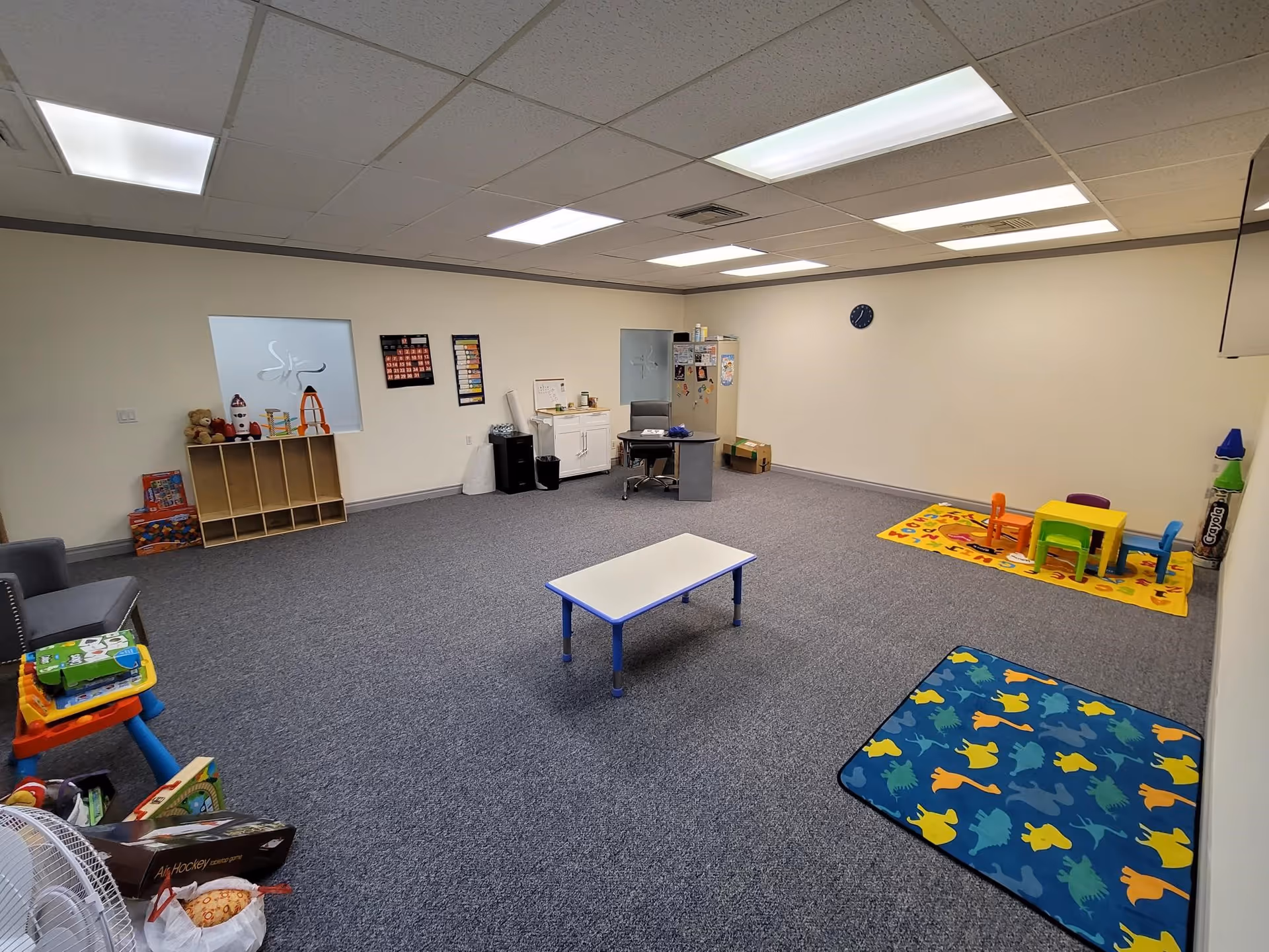 Playroom with children's toys, mats, and small furniture in a senior facility.
