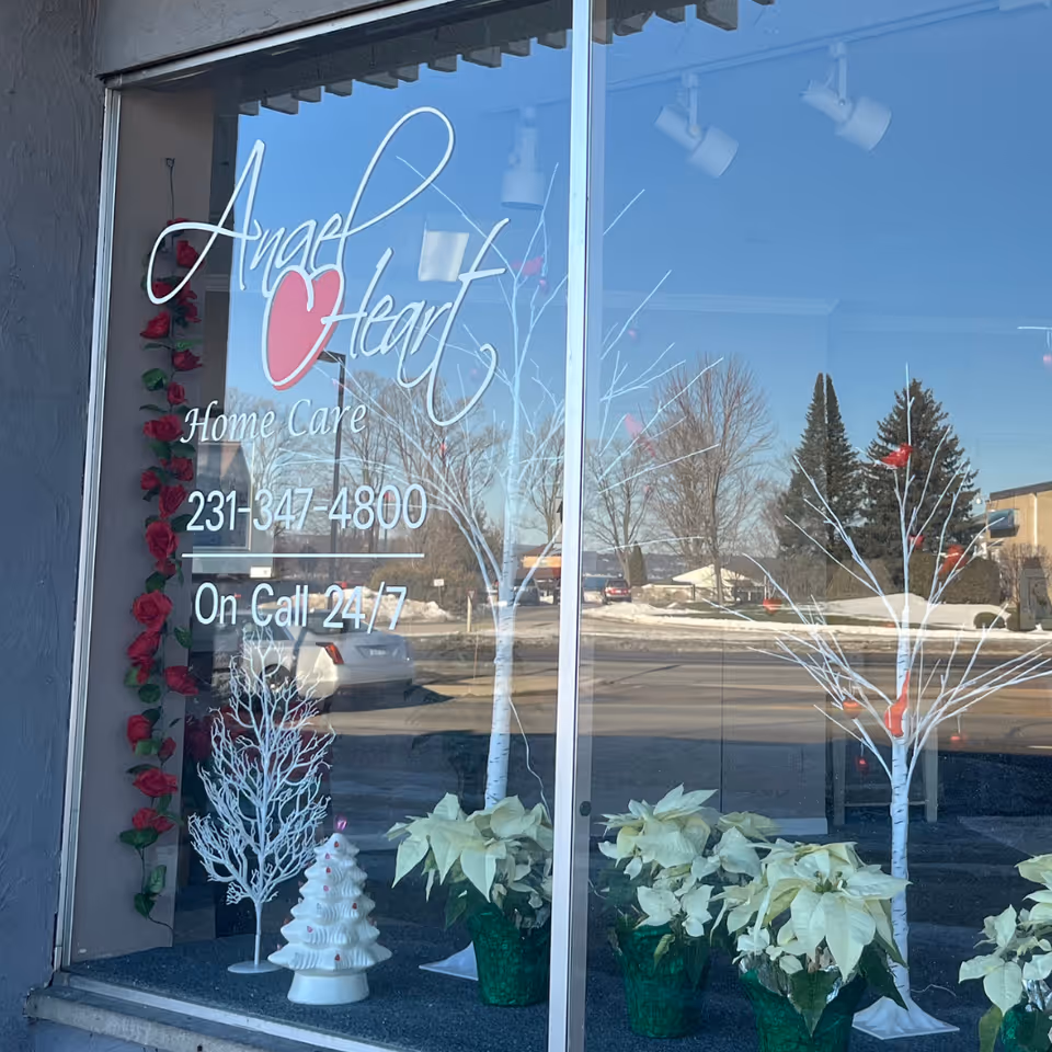Storefront window for Angel Heart Home Care with phone number and decorations