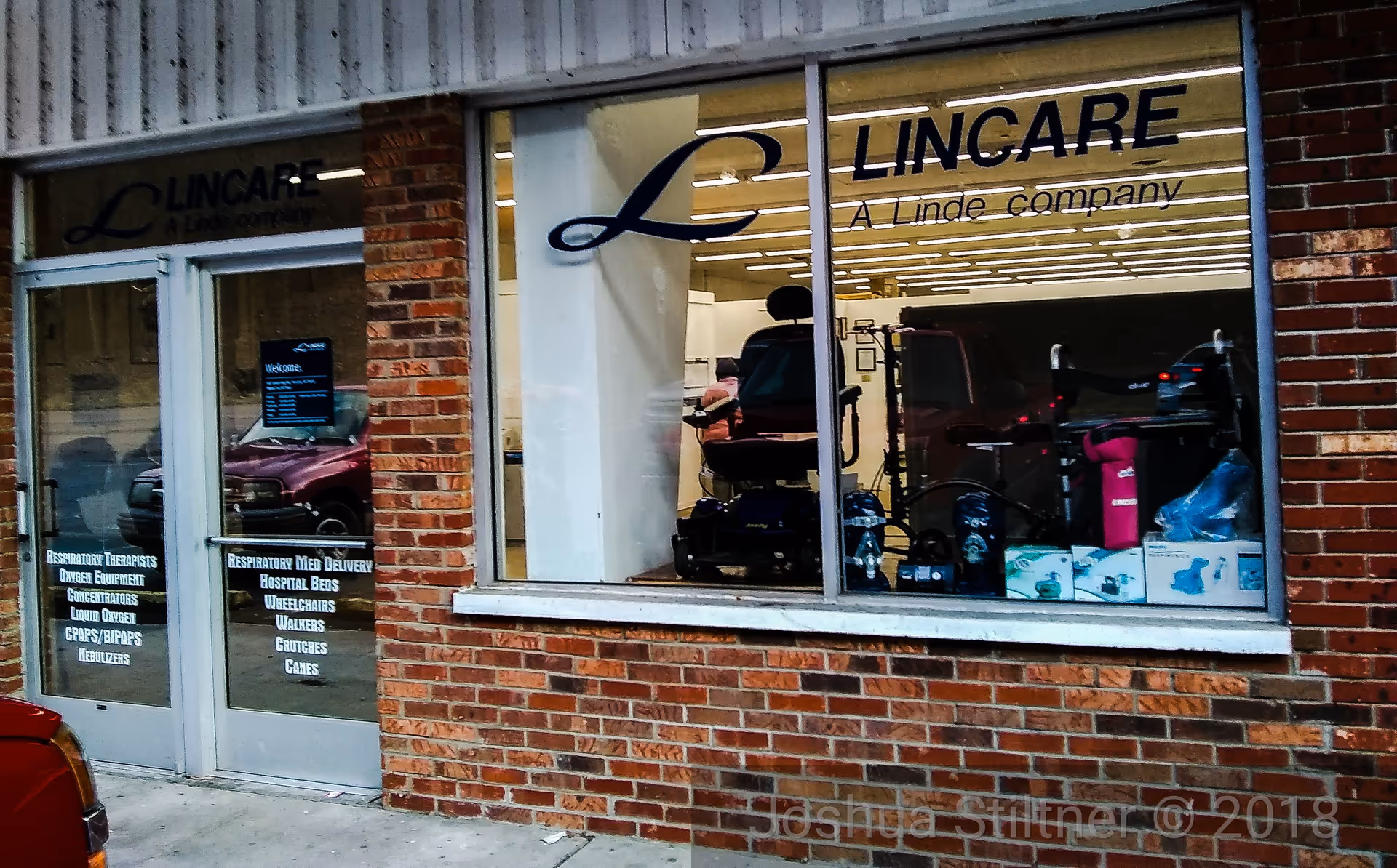 Brick storefront with LINCARE sign and display of medical equipment in window