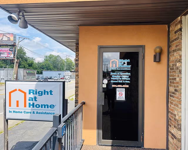 Exterior view of Right at Home entrance with sign and glass door.