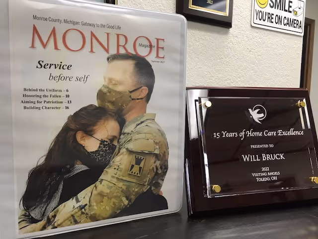 Indoor reception area at Visiting Angels with Monroe magazine and a milestone plaque.