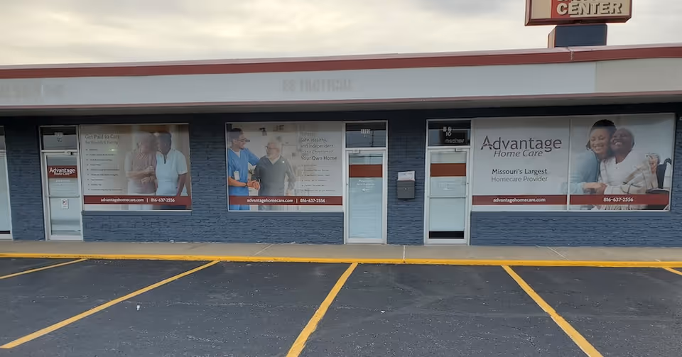 Exterior storefront of Advantage Home Care with large windows and banners.