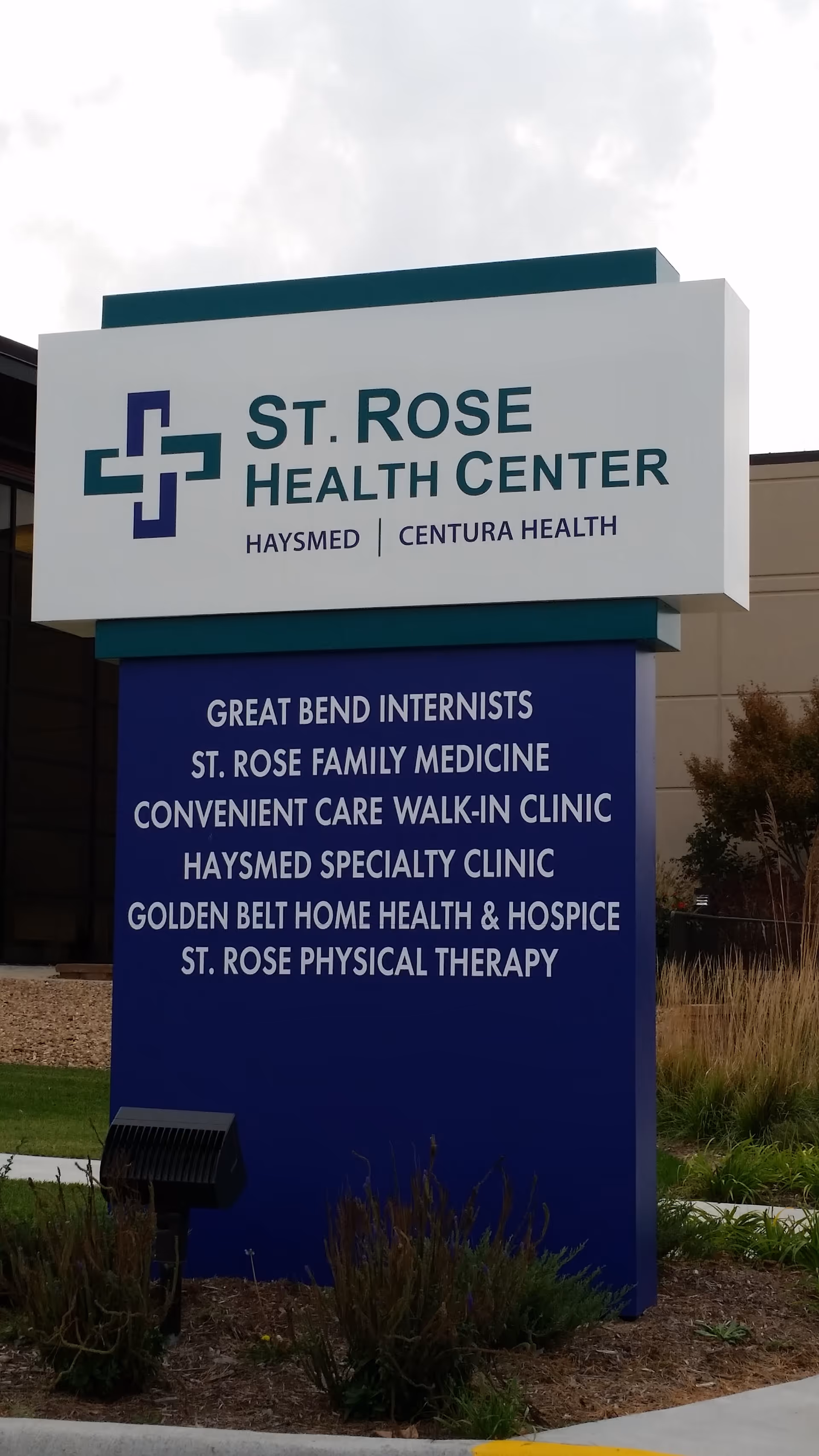 Outdoor sign for St. Rose Health Center displaying services and clinics.