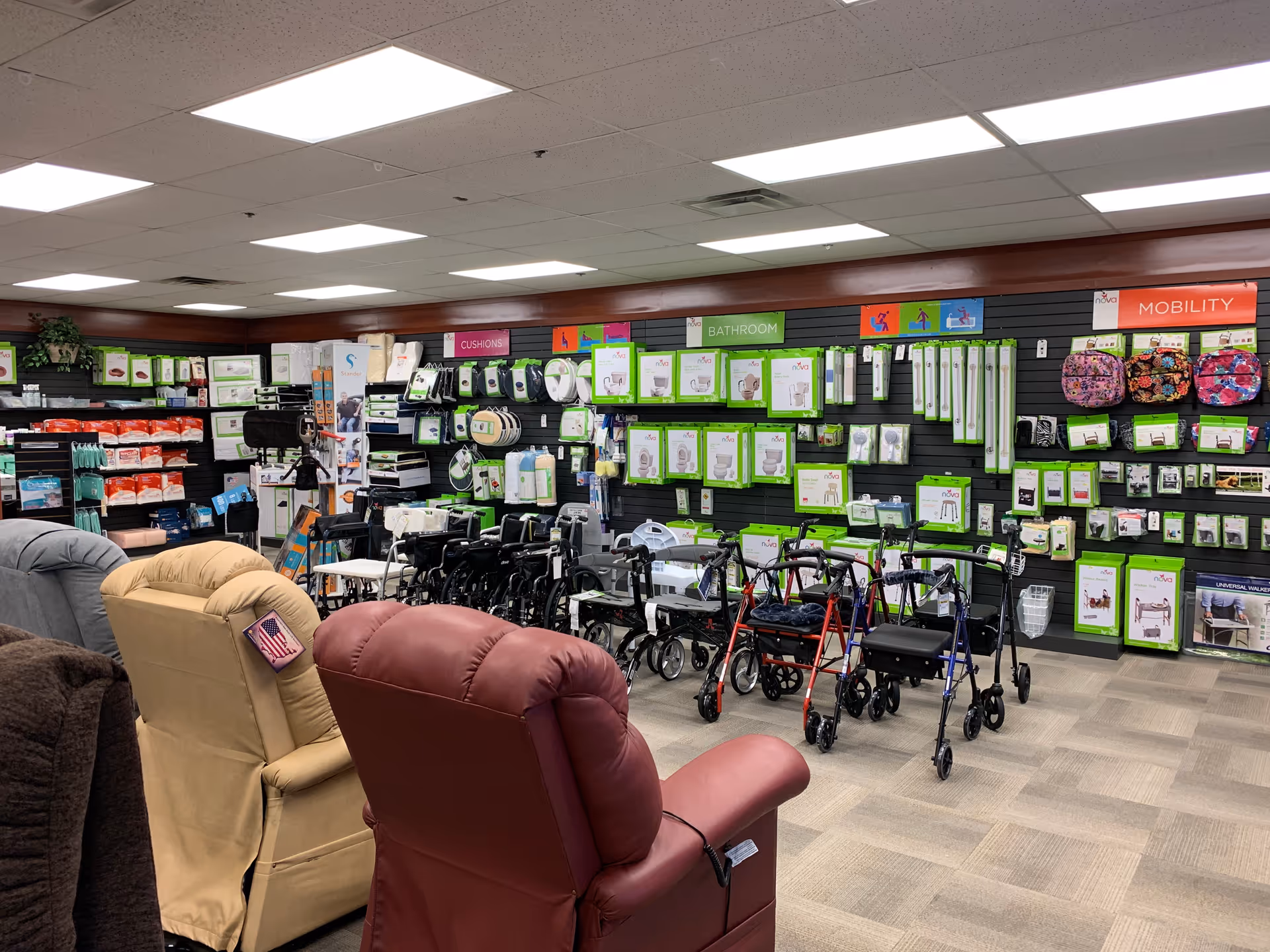 Indoor showroom with walkers, chairs, and mobility aids on display along walls.