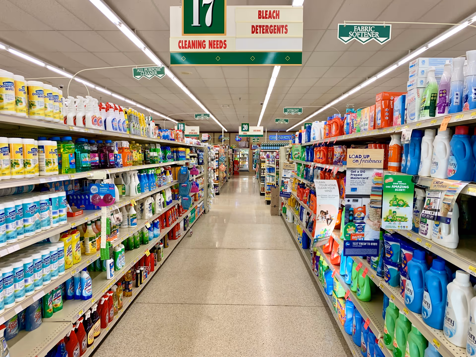 Discount Drug Mart store aisle filled with cleaning supplies and detergents.