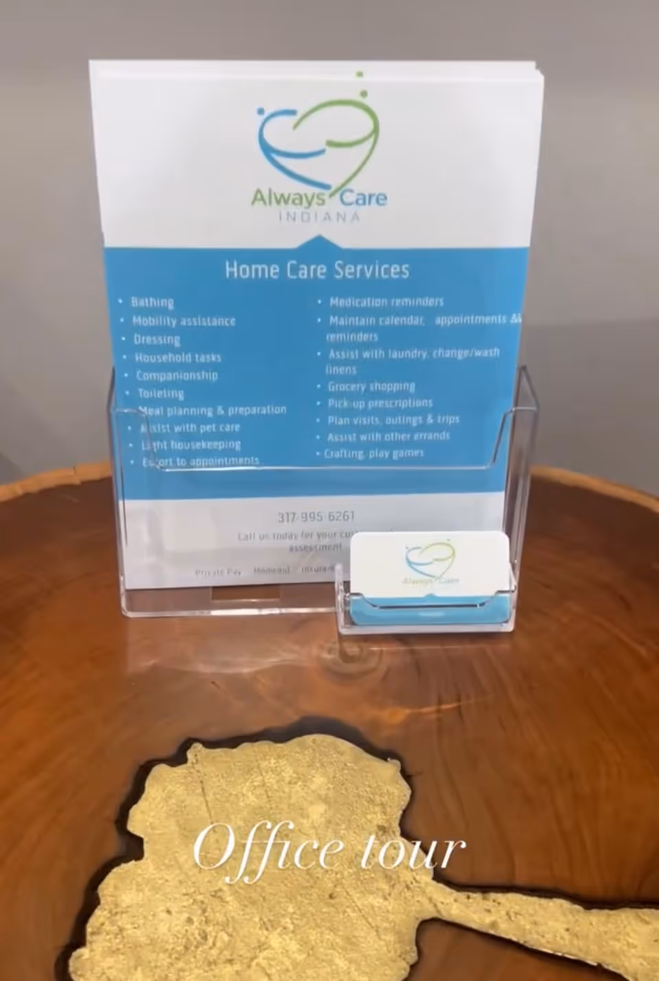 Always Care Indiana Home Care Services brochure on a wooden table beside a sign.