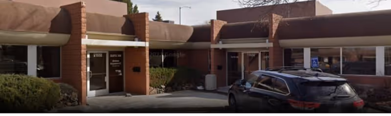 Exterior view of the Senior Helpers facility entrance with a car parked outside.