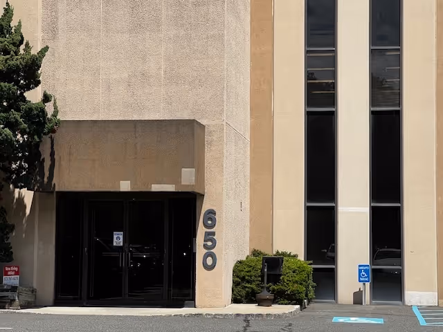 Exterior view of BAYADA Assistive Care building entrance with 650 address and handicap parking.