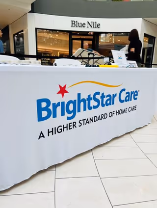 BrightStar Care promotional table in a mall atrium with Blue Nile storefront in background.