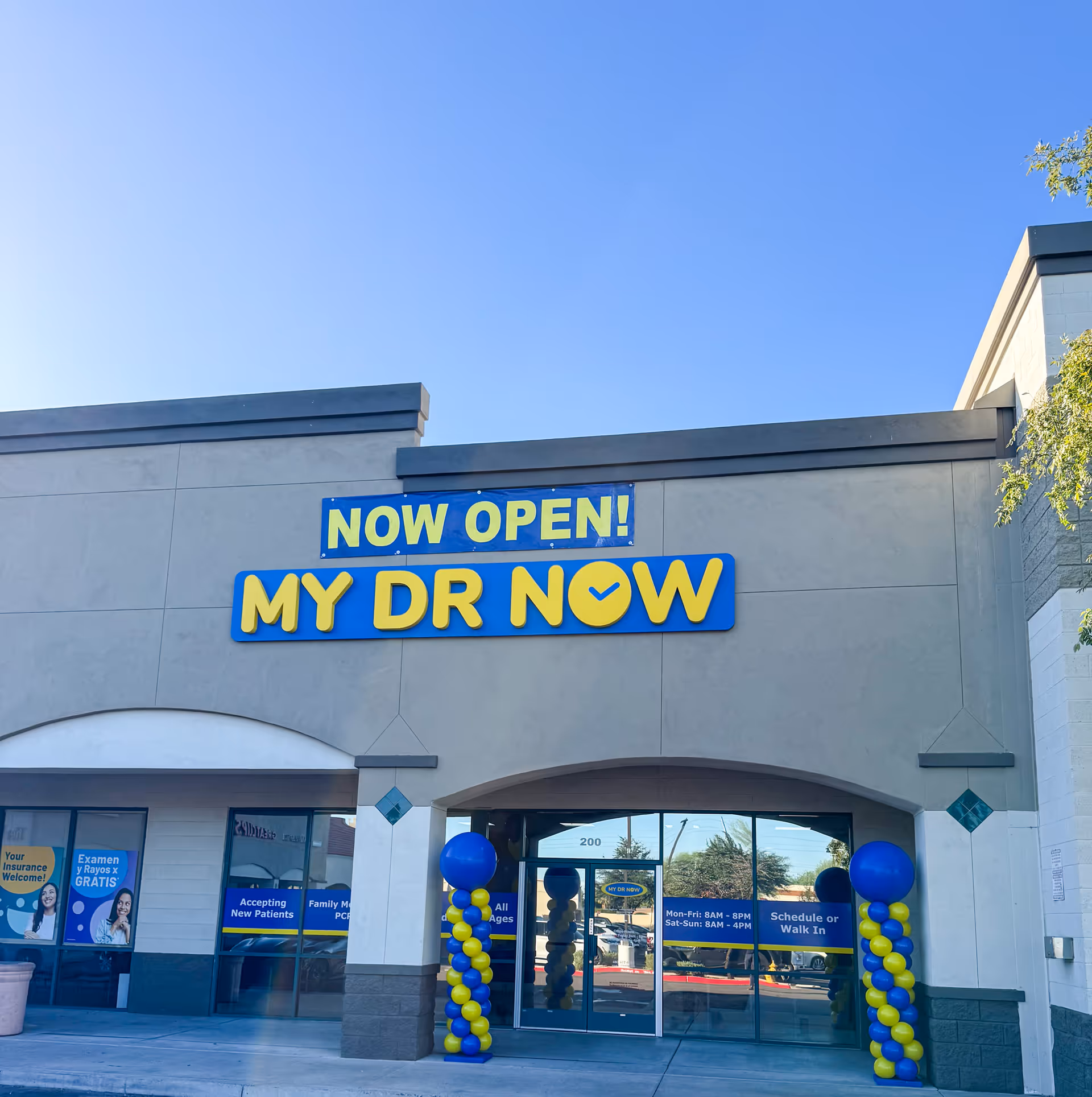 Front exterior of MY DR NOW clinic with a Now Open sign and blue-yellow balloons.