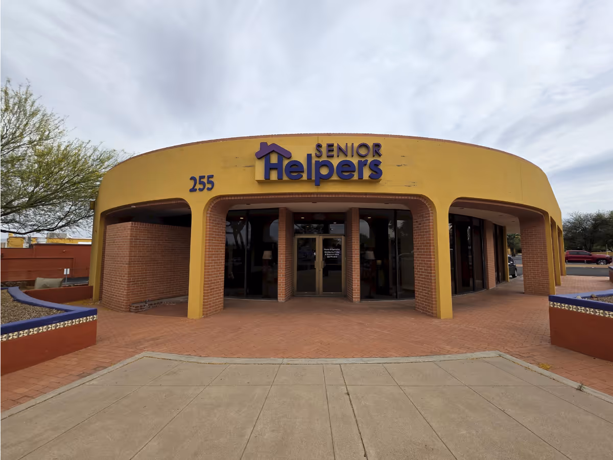 Yellow Senior Helpers building with arched entrances and glass doors.