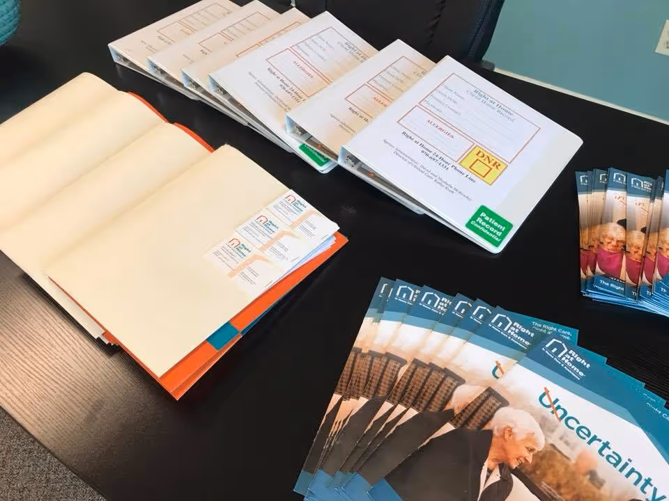 Desk with stacked brochures and pamphlets for Right at Home senior care services.