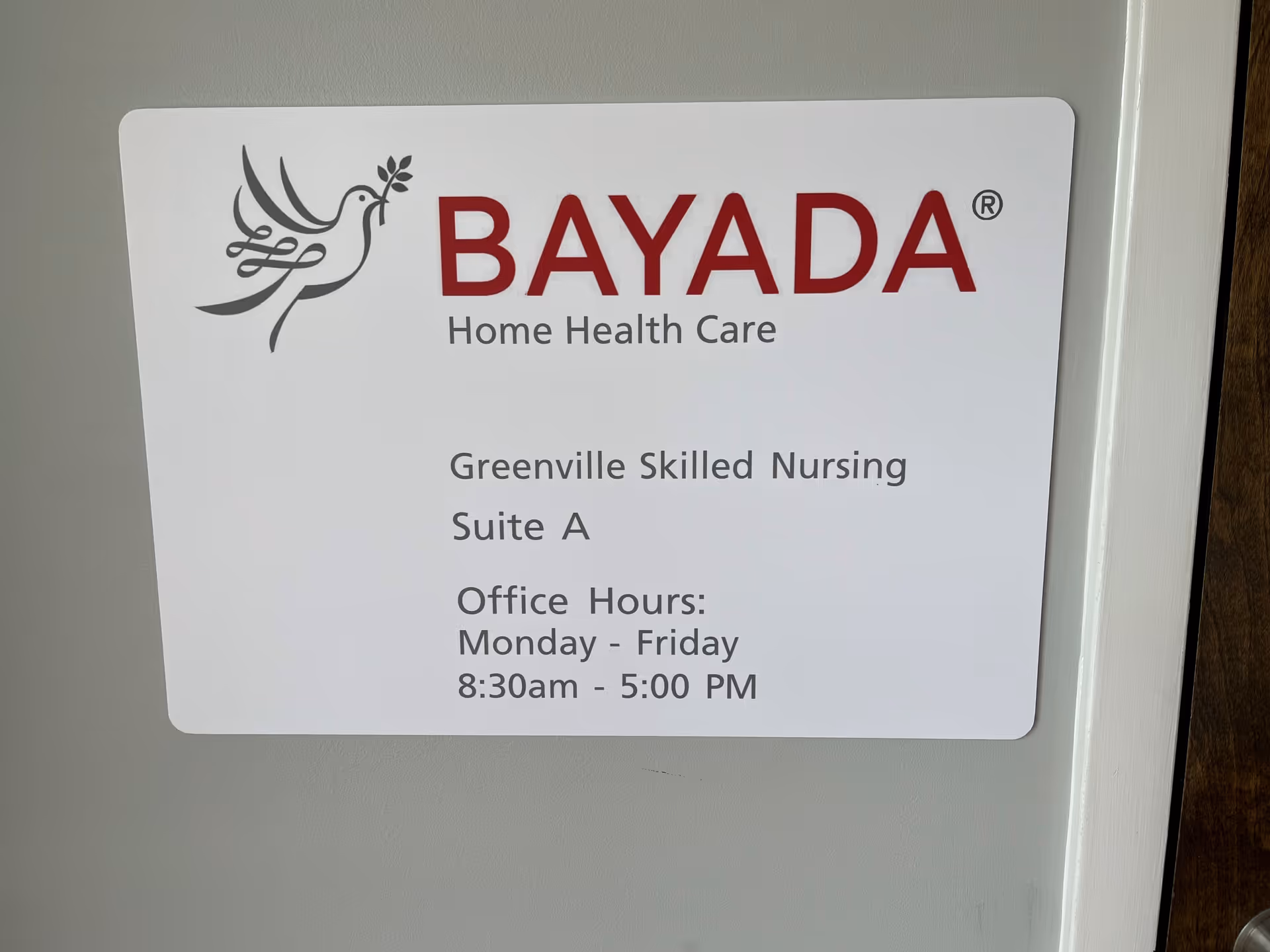 Bayada Home Health Care sign on wall listing Greenville Skilled Nursing Suite A and office hours