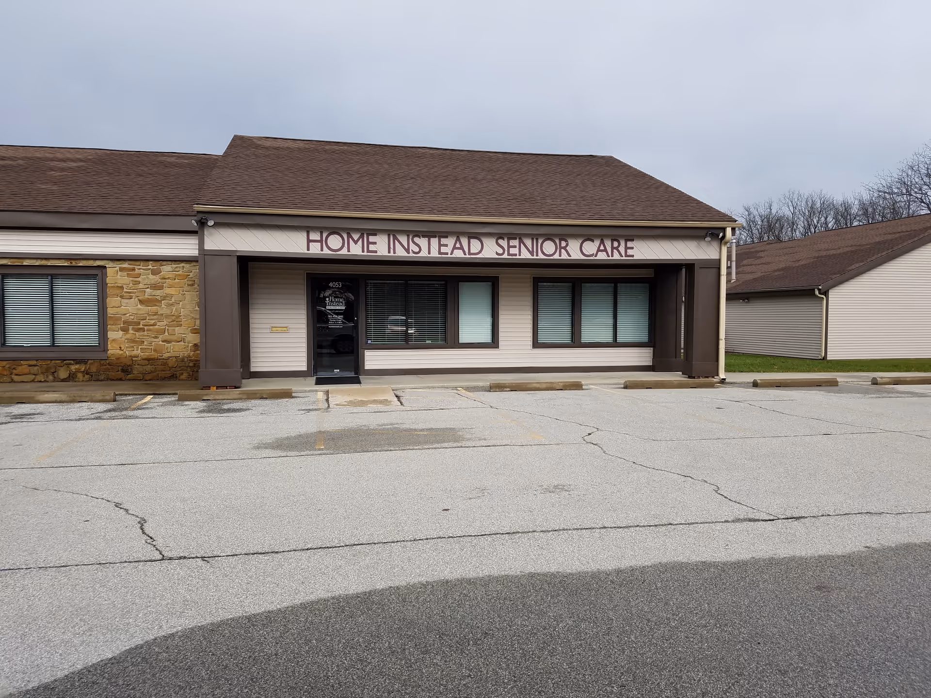 Front exterior of Home Instead Senior Care building with entrance and windows.